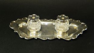 An Edwardian silver desk stand with two cut glass ink wells on silver tray (by William Hutton & Sons