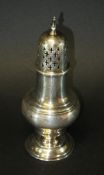 An Edwardian silver sugar caster of ogee form raised on a circular foot (by Herbert Edward Barker &