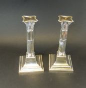 A pair of Edwardian silver Corinthian column table candlesticks (by Henry Wigfull for Lee & Wigfull,
