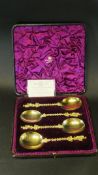 A set of four Victorian silver gilt fruit spoons with figural decoration in the Eastern manner (by