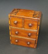 A Victorian mahogany and parquetry inlaid miniature chest of two short and two long drawers with