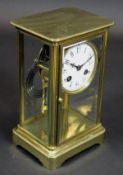 A late 19th Century French brass cased four glass mantel clock,