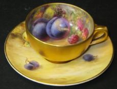 A Royal Worcester fruit decorated miniature cabinet cup and saucer with gilt-washed exterior, the