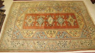 A Turkish carpet, the five central diamond shaped medallions in cream, pale blue,