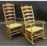 A pair of Paul Spriggs oak framed rush seat ladder back rocking chairs