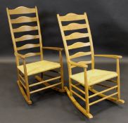 A pair of Paul Spriggs oak framed rush seat ladder back rocking chairs