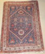 A Caucasian rug, the centrefield with stylised floral and foliate decoration in dark blue, green,