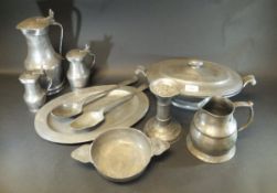 A collection of pewter wares to include three lidded jugs, oval plate, two spoons, lidded tureen,