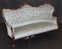 A Victorian walnut framed salon sofa with carved and moulded show frame and pale blue buttoned