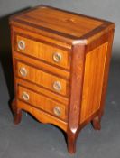 A 19th Century walnut and mahogany miniature chest of three drawers in the Louis XV taste,