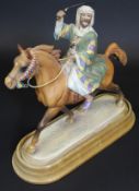 A Beswick figure of a Bedouin Arab warrior on horseback, No'd. 2275 to base, 26.5 cm long, raised on