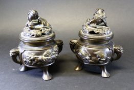 A pair of circa 19th Century Chinese bronze censers with lion and ball finials,