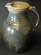 A Ray Finch jug of ribbed form in blue/brown glaze,