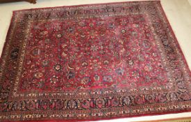 A Persian carpet, the all-over stylised floral and foliate decoration in blue, cream,