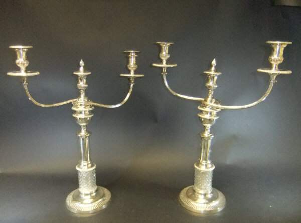 An unusual pair of 19th Century plated candelabra, two branch, three light,