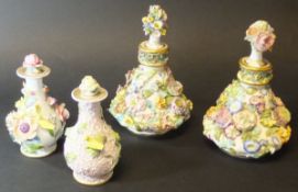 A pair of early 19th Century floral encrusted porcelain scent bottles of pear form with stoppers,