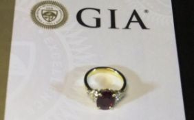 WITHDRAWN  An 18 carat gold dress ring set with central oval brilliant cut Burmese ruby, approx 3.