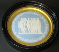 A 19th Century Wedgwood blue jasper dip circular wall plaque decorated with classical figures within