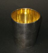 WITHDRAWN A Regency silver beaker of plain tapering form with gilt washed interior,