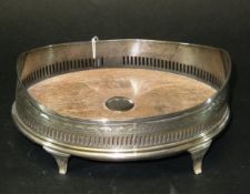 A George III oval silver and pierced coaster on four scroll feet (by Solomon Hougham, London, 1796),