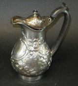 A George III silver baluster shaped water jug with later Victorian embossed decoration (possibly by