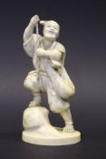 A 19th Century Japanese Meiji period carved ivory okimono as a man with bag and rope (possibly