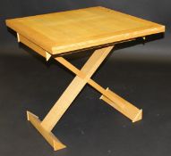 A modern ash foldover tea table on X-frame base by Sean Feeney,