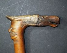 A carved wooden walking stick with horse head and moustached face inscribed "Kepkura", 88.5 cm