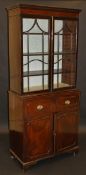 A late Regency mahogany secretaire bookcase, the moulded satinwood and rosewood strung cornice