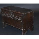 A 17th Century oak six plank coffer of  small proportions, the rising lid with moulded front edge