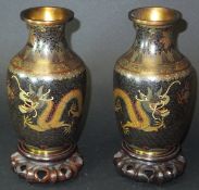 A pair of early 20th Century Chinese cloisonné vases with flared rims, the body decorated with