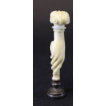 A Victorian carved ivory handled seal as a hand holding a seal with carved hardstone facia, 8.2 cm