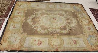 WITHDRAWN   An Aubusson carpet, the central floral medallion in pale green,