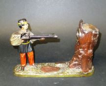 A late 19th Century iron money box in the form of a soldier shooting at a tree,