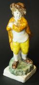 A circa 1790 Staffordshire Pearlware figure of "Winter" as a man in cloak and hat,