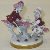 A 20th Century Continental porcelain figure group "See-saw",