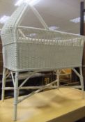 A white painted bamboo and wicker weave cot