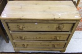 A pine chest of three long drawers on bracket feet with turned handles