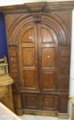 A 19th Century pitch pine free standing corner cupboard, the later moulded cornice with dentil