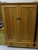 A South African yellow wood two-door wardrobe with drawer below (to match lot 580A and to be sold