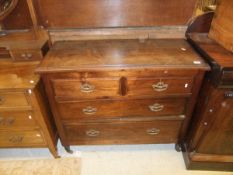 An Edwardian oak chest of two short over two long drawers with brass swing handles,