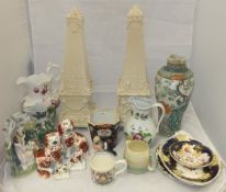 A collection of decorative china wares to include a pair of large cream pottery obelisks raised on
