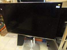 Two Bang & Olufsen televisions on stands,