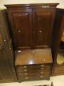 A mahogany bureau bookcase with four drawers on bracket feet