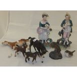 A pair of 19th Century Staffordshire pottery figures depicting a shepherd and a shepherdess,