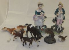 A pair of 19th Century Staffordshire pottery figures depicting a shepherd and a shepherdess,