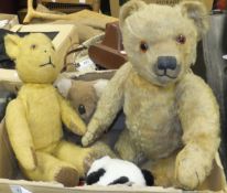 A vintage gold plush teddy bear with jointed limbs and glass eyes, a further vintage teddy bear,