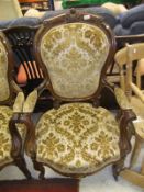 A set of four Victorian salon elbow chairs in a cream and pale gold patterned upholstery