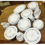 A collection of Royal Doulton "Burgundy" pattern dinner wares to include lidded tureens,