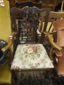A Georgian elbow chair in the Chippendale manner with a floral fabric covered seat